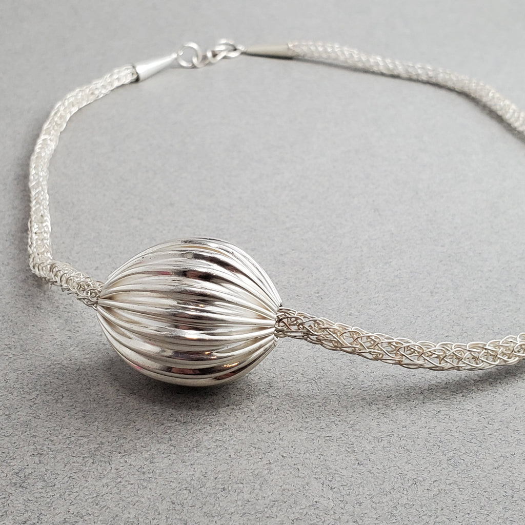 Asymmetrical Pleated Hollow Silver Bead on Handmade Woven