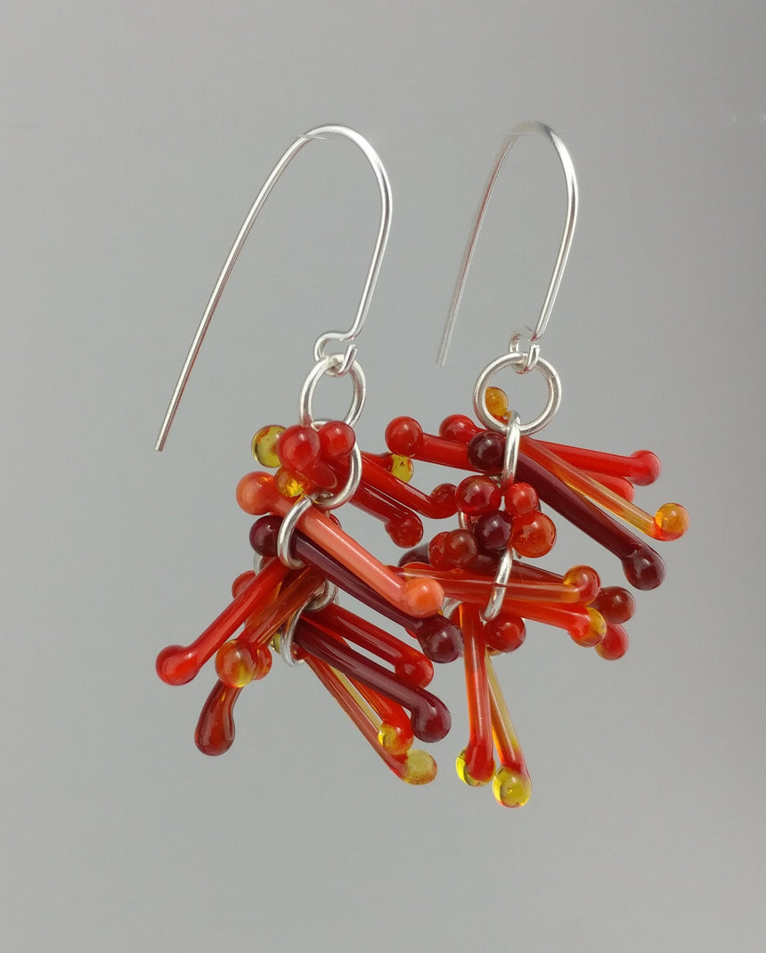 Shades of Red Kinetic Earrings of Lampwork Glass Jack with sterling silver ear wires.