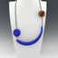 Royal Blue Hollow Bead and Square Multi-colored Bead on hand woven multi-color Kumihimo necklace, silver cones and hook closing