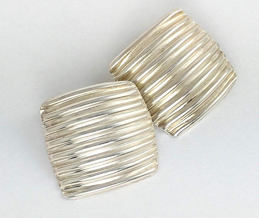 Fine silver sheet corrugated into tiny ridges and then formed into jewelry pieces.