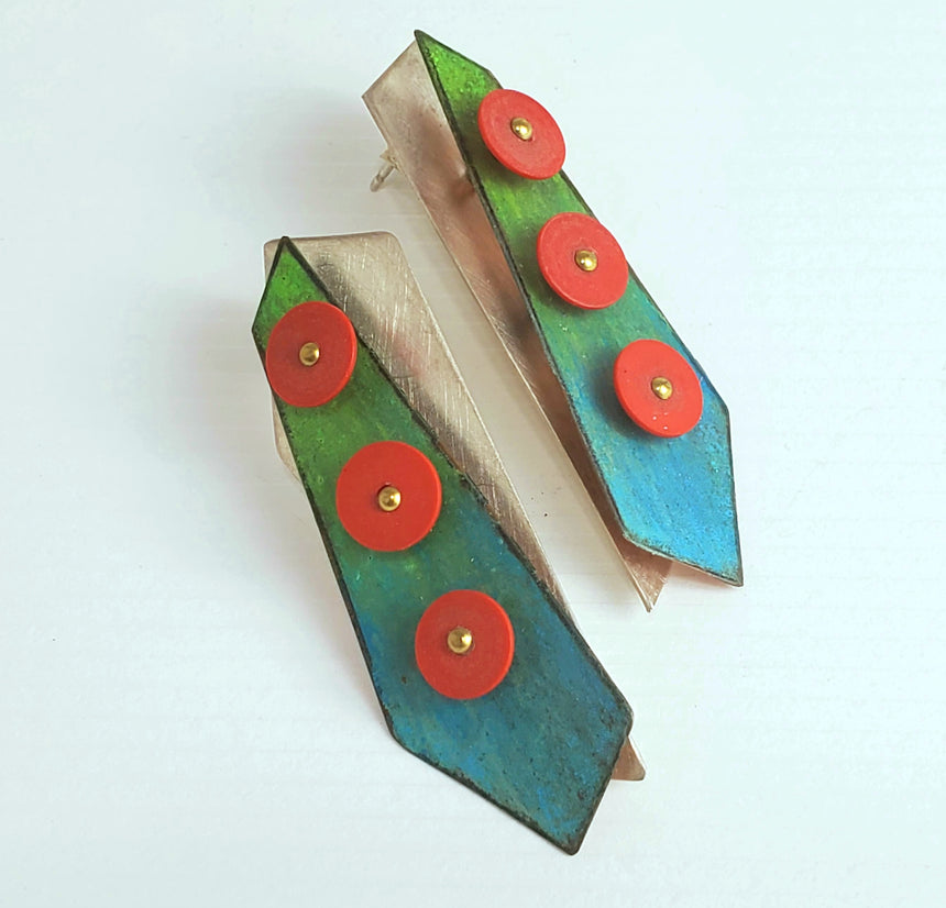 Bright tropical colored  blue and green Prisma colored crayon is blended onto copper sheet.  These is then riveted onto sterling silver and has an accent of three bright red African record beads to create a three layer pair of earrings.
