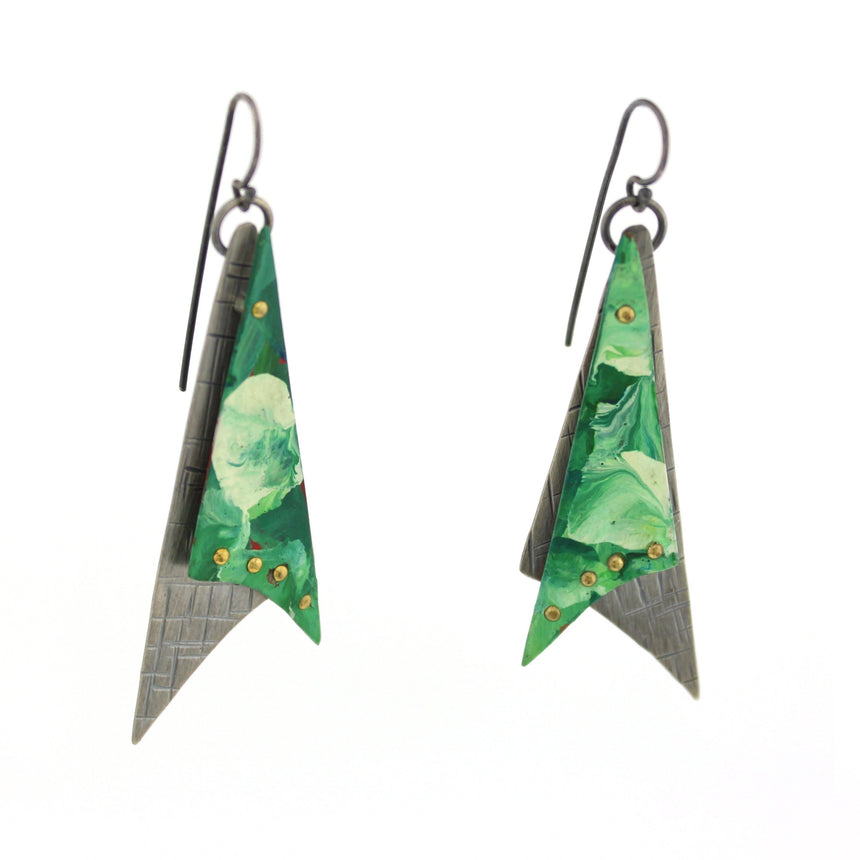 Triangles with tails in copper are painted in swirls of green and white acrylic paint.  These are then riveted to opposing hammered sterling silver with a back/gray patina creating two dimensional earrings.  These hang from hand made french wires making them kinetic. 