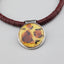 Enameled Leopard Design in a Sterling Frame threaded onto rust colored African Record Beads, Sterling Clasp, Great for layering, Animal Print Enamel Pendant